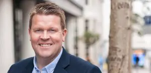 Smiling Caucasian man in blue sport coat