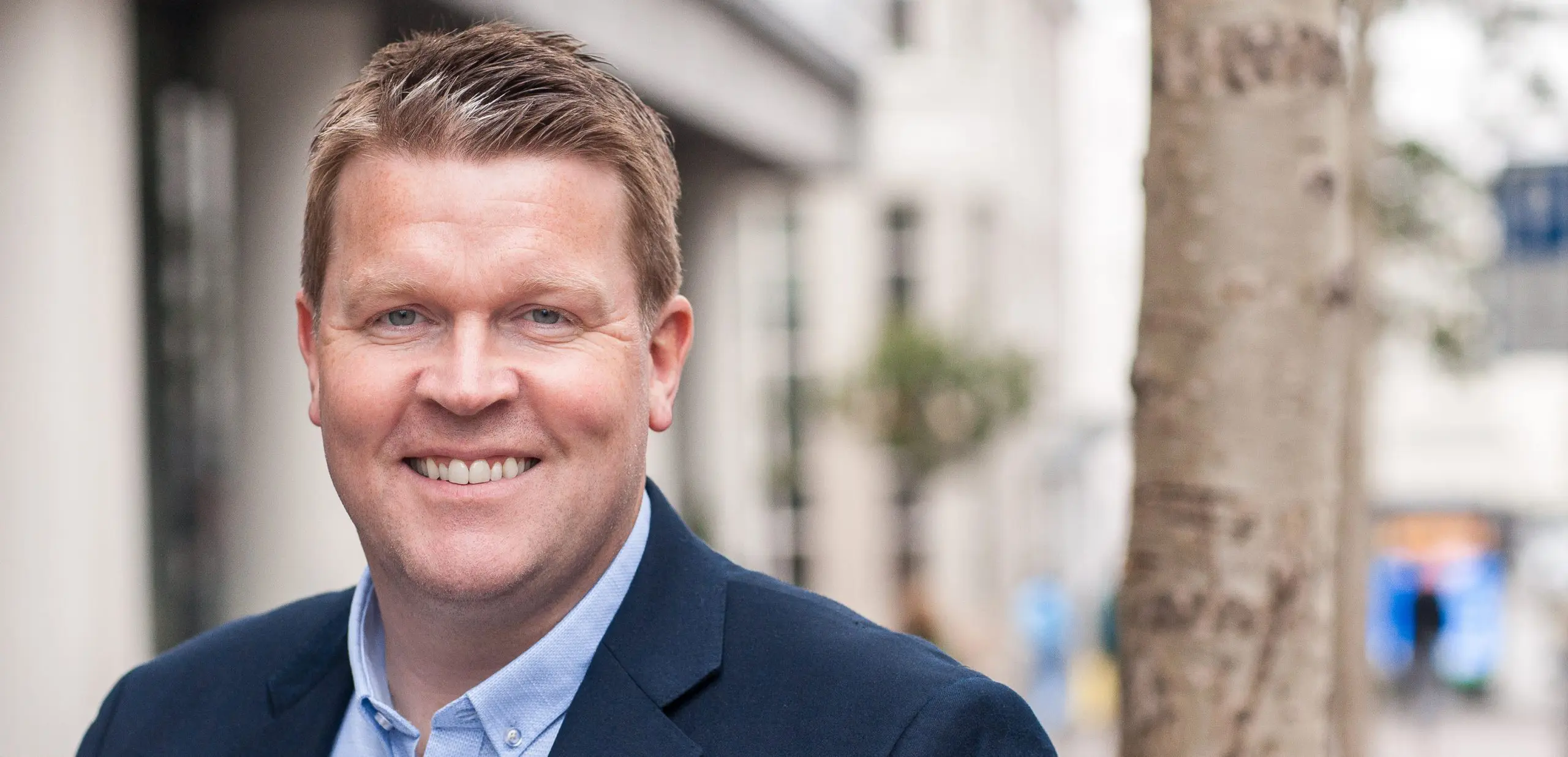 Smiling Caucasian man in blue sport coat